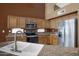 Updated kitchen with granite counters, stainless appliances and light wood cabinetry at 592 W Harvard Ave, Gilbert, AZ 85233