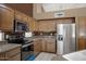 Kitchen featuring stainless steel appliances, granite countertops, and custom cabinetry at 592 W Harvard Ave, Gilbert, AZ 85233