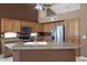 Kitchen island with granite countertops, stainless steel appliances, and custom cabinets at 592 W Harvard Ave, Gilbert, AZ 85233