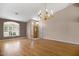 Large living room boasting hardwood floors, natural light from a big window, and modern lighting fixtures at 592 W Harvard Ave, Gilbert, AZ 85233