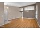 Spacious living area with hardwood floors, stylish lighting, and a view into the next room at 592 W Harvard Ave, Gilbert, AZ 85233