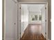 Open doorway leads to a living room featuring hardwood floors and large windows at 592 W Harvard Ave, Gilbert, AZ 85233