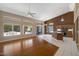 Open living area featuring hardwood floors and large windows with a view to the backyard at 592 W Harvard Ave, Gilbert, AZ 85233
