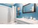 Stylish bathroom with updated vanity, framed mirror, and shower-tub combo at 6945 E Osborn Rd # B, Scottsdale, AZ 85251