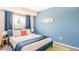 Cozy bedroom with blue walls, geometric rug, and a large window providing natural light at 6945 E Osborn Rd # B, Scottsdale, AZ 85251
