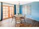 Dining area features a modern table and stylish wood-look floors at 6945 E Osborn Rd # B, Scottsdale, AZ 85251