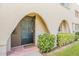 Charming front entrance with unique arched entryway and secure iron gate at 6945 E Osborn Rd # B, Scottsdale, AZ 85251
