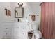 Bathroom with a white vanity, decorative mirror, and a toilet with basket at 743 W Ocotillo Rd, Phoenix, AZ 85013