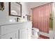 Bathroom with a white vanity, decorative mirror, and a toilet with basket at 743 W Ocotillo Rd, Phoenix, AZ 85013