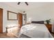 Bedroom with wood floors, a bench, a large mirror, and two matching nightstands at 743 W Ocotillo Rd, Phoenix, AZ 85013