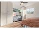 A bedroom featuring two windows, wood floors, a large closet and a dresser at 743 W Ocotillo Rd, Phoenix, AZ 85013