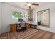 A bedroom with wood floors, a ceiling fan, a mirror, a desk and a chair at 743 W Ocotillo Rd, Phoenix, AZ 85013