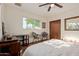 Bright bedroom with wood flooring, a ceiling fan, and natural light from windows at 743 W Ocotillo Rd, Phoenix, AZ 85013