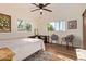 Bright bedroom with wood flooring, a ceiling fan, and natural light from windows at 743 W Ocotillo Rd, Phoenix, AZ 85013