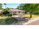 Charming single-story home with mature landscaping, covered porch, and driveway at 743 W Ocotillo Rd, Phoenix, AZ 85013