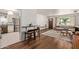 Open-concept living room featuring modern furnishings, hardwood floors, and a connected kitchen at 743 W Ocotillo Rd, Phoenix, AZ 85013
