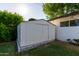 Backyard shed features storage with mature landscaping and a white brick perimeter at 743 W Ocotillo Rd, Phoenix, AZ 85013