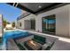 Luxury backyard with pool, fire pit seating area, and seamless indoor-outdoor living at 8038 E Clarendon Ave, Scottsdale, AZ 85251
