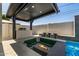Outdoor kitchen, a fire pit and a spa are combined for luxury backyard living at 8038 E Clarendon Ave, Scottsdale, AZ 85251