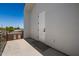 Minimalist balcony with concrete flooring and a white stucco wall at 8038 E Clarendon Ave, Scottsdale, AZ 85251