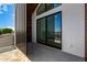 Upstairs balcony featuring modern railings, wood accents, and sleek sliding glass doors at 8038 E Clarendon Ave, Scottsdale, AZ 85251