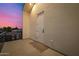 Balcony view showcasing a wall with a door against a vibrant, colorful sunset sky at 8038 E Clarendon Ave, Scottsdale, AZ 85251