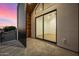Balcony view showcasing a room through a large glass slider door and a vibrant, colorful sunset sky at 8038 E Clarendon Ave, Scottsdale, AZ 85251