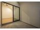 Balcony view into an empty room through a large glass slider door with hardwood flooring at 8038 E Clarendon Ave, Scottsdale, AZ 85251