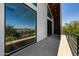 Upstairs balcony with modern railings, wood accents, and scenic neighborhood views at 8038 E Clarendon Ave, Scottsdale, AZ 85251