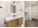 Bathroom features a modern vanity with black hardware, an illuminated mirror, and access to the closet at 8038 E Clarendon Ave, Scottsdale, AZ 85251