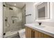 Modern bathroom featuring a glass-enclosed shower, sleek vanity, and a lighted mirror at 8038 E Clarendon Ave, Scottsdale, AZ 85251