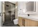 Modern bathroom showcasing a glass shower, white countertop, and wooden vanity at 8038 E Clarendon Ave, Scottsdale, AZ 85251