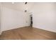 Minimalist bedroom with light hardwood floors and a bright white interior offers a serene living space at 8038 E Clarendon Ave, Scottsdale, AZ 85251