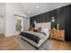 Elegant bedroom with a padded headboard, stylish lighting, and hardwood floors at 8038 E Clarendon Ave, Scottsdale, AZ 85251