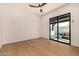 Bedroom with hardwood floors and a large sliding glass door with access to the outdoor patio at 8038 E Clarendon Ave, Scottsdale, AZ 85251
