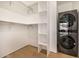 Walk-in closet featuring white shelving and a stacked washer and dryer at 8038 E Clarendon Ave, Scottsdale, AZ 85251