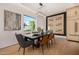 Chic dining room featuring modern lighting, stylish decor, and a view of the outdoors at 8038 E Clarendon Ave, Scottsdale, AZ 85251