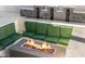 Outdoor seating around modern fire pit with views of stone water features at 8038 E Clarendon Ave, Scottsdale, AZ 85251
