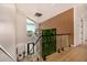 Open foyer features modern lighting, hardwood floors, glass railing and an accent wall at 8038 E Clarendon Ave, Scottsdale, AZ 85251