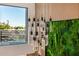 View of the foyer with a modern chandelier, accent wall, and large window at 8038 E Clarendon Ave, Scottsdale, AZ 85251