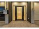Inviting front entrance with sleek design elements and stylish ambient lighting at 8038 E Clarendon Ave, Scottsdale, AZ 85251