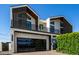 Contemporary two-story home with sleek black accents and modern architectural design at 8038 E Clarendon Ave, Scottsdale, AZ 85251