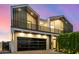 Striking two-story home featuring a black framed garage and a sleek, contemporary design at 8038 E Clarendon Ave, Scottsdale, AZ 85251