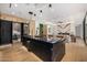 Open-concept kitchen with a large island, wine fridge, and high-end appliances at 8038 E Clarendon Ave, Scottsdale, AZ 85251