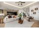 Open-concept living space with stylish decor, modern lighting, and a seamless flow to the kitchen at 8038 E Clarendon Ave, Scottsdale, AZ 85251