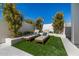 Relaxing poolside lounge area with comfortable chairs on the artificial grass at 8038 E Clarendon Ave, Scottsdale, AZ 85251