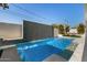 Inviting pool with a waterfall feature, complemented by stylish lounge chairs at 8038 E Clarendon Ave, Scottsdale, AZ 85251