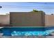 Backyard pool featuring a modern water feature wall and clear blue water at 8038 E Clarendon Ave, Scottsdale, AZ 85251
