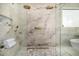Elegant walk-in shower with dual shower heads and marble accents at 8038 E Clarendon Ave, Scottsdale, AZ 85251