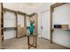 Luxurious walk-in closet with custom shelving, a glass table, and elegant lighting at 8038 E Clarendon Ave, Scottsdale, AZ 85251